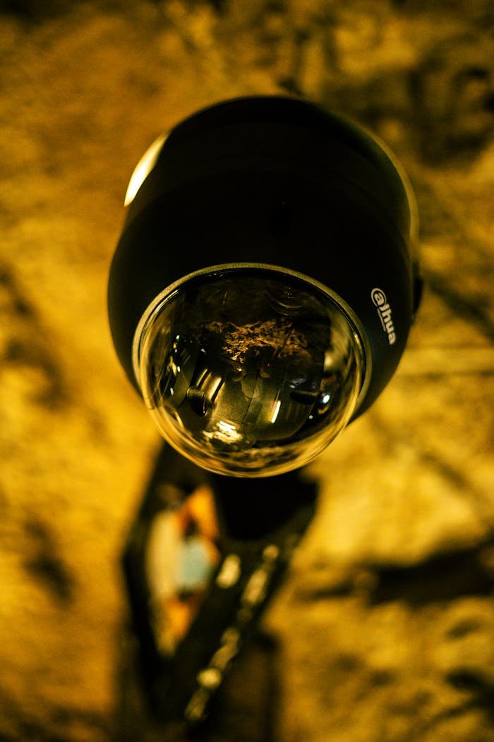 Detailed close-up image of a security surveillance camera lens indoors.